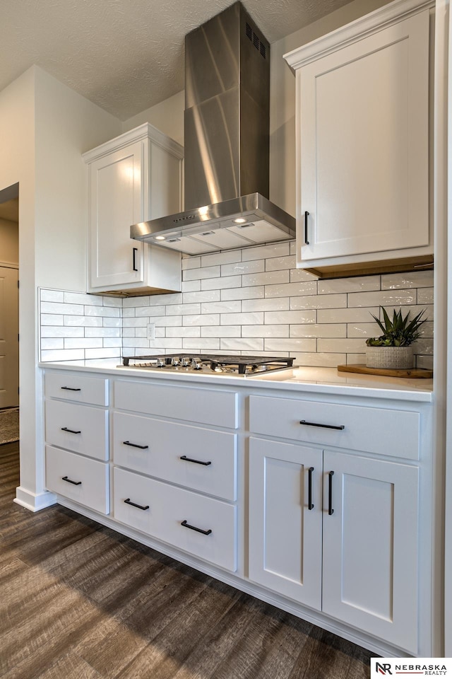 19015 Ranch Dr, Papillion, NE 68046 - kitchen featuring wall chimney range hood, dark wood-style flooring, stainless steel gas stovetop, and decorative backsplash