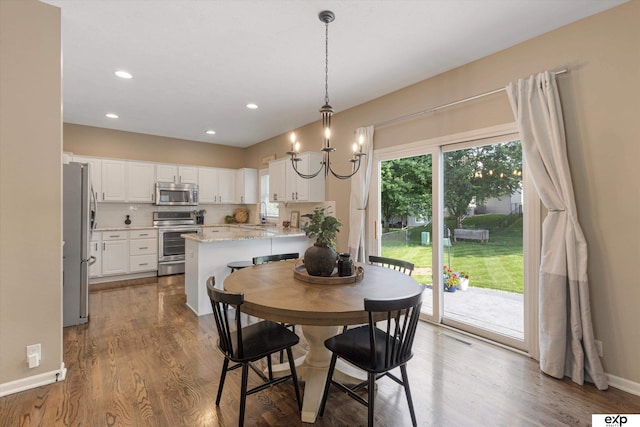 16454 Drexel St, Omaha, NE 68135 - dining room with wood finished floors, a chandelier, and recessed lighting