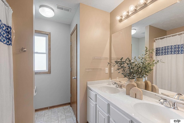 16454 Drexel St, Omaha, NE 68135 - bathroom with double vanity and a textured ceiling