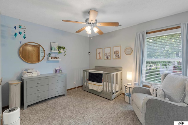 16454 Drexel St, Omaha, NE 68135 - bedroom featuring light colored carpet, a crib, and a ceiling fan