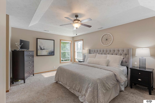 16454 Drexel St, Omaha, NE 68135 - bedroom featuring light carpet, a textured ceiling, a tray ceiling, and a ceiling fan