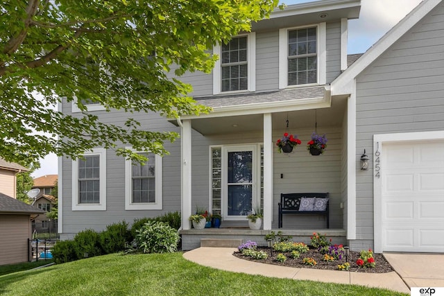 16454 Drexel St, Omaha, NE 68135 - entrance to property featuring covered porch, a garage, and a lawn