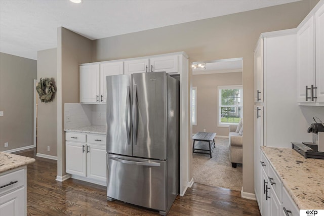 16454 Drexel St, Omaha, NE 68135 - kitchen featuring freestanding refrigerator, dark wood-style flooring, white cabinetry, and backsplash