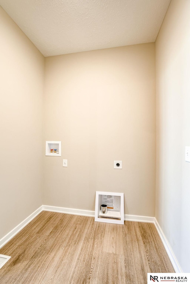 11152 Portage Dr, Papillion, NE 68046 - laundry area with electric dryer hookup, hookup for a washing machine, and light wood-style floors