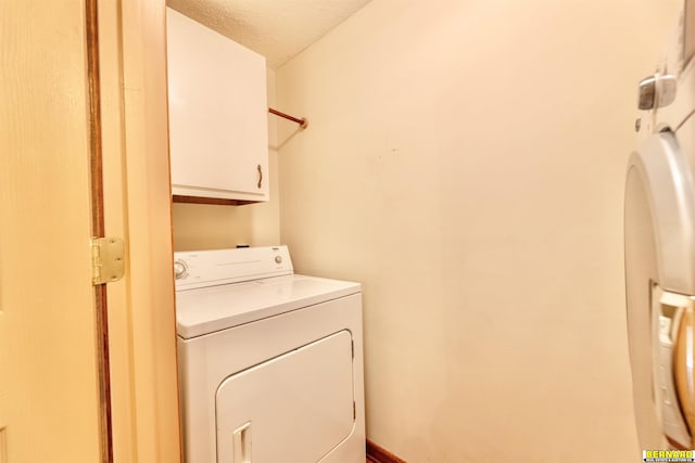 1916 S 42nd Rd, Talmage, NE 68448 - laundry area featuring washer / clothes dryer, cabinet space, a textured ceiling, and arched walkways