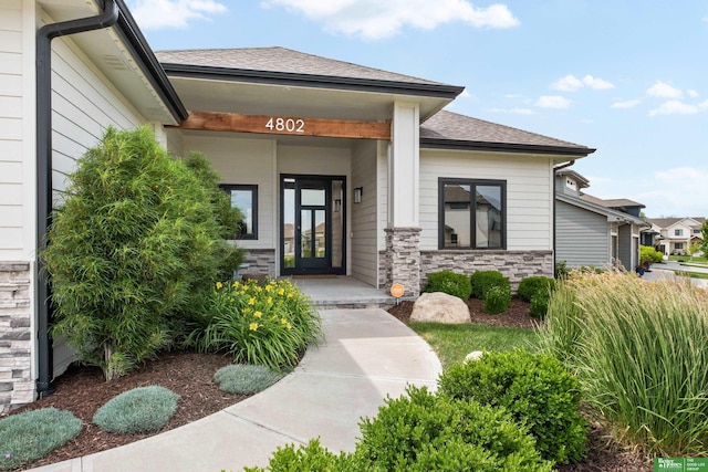 4802 N 187th Ave, Elkhorn, NE 68022 - entrance to property with roof with shingles, french doors, and stone siding