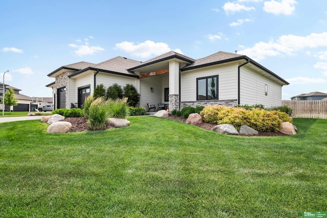 4802 N 187th Ave, Elkhorn, NE 68022 - view of front of home featuring an attached garage, concrete driveway, and stone siding