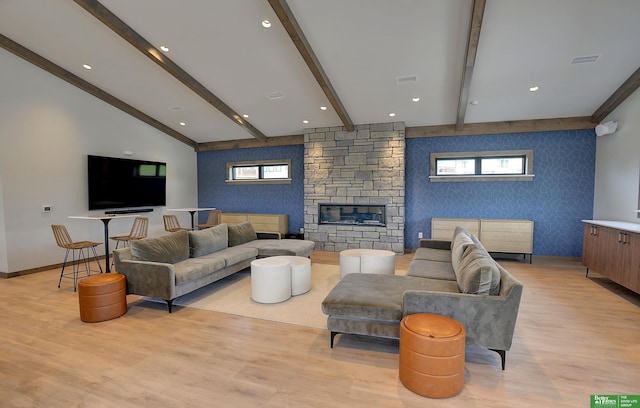 4802 N 187th Ave, Elkhorn, NE 68022 - living area featuring an accent wall, light wood-style flooring, a fireplace, wallpapered walls, and beam ceiling