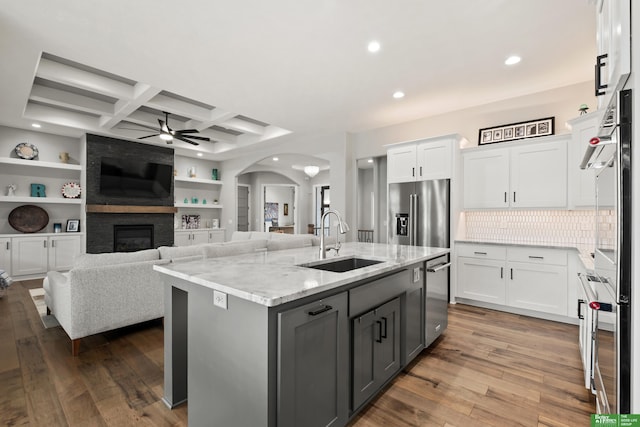 4802 N 187th Ave, Elkhorn, NE 68022 - kitchen featuring stainless steel appliances, gray cabinets, ceiling fan, arched walkways, and white cabinetry