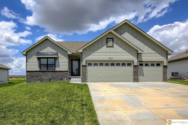 12618 Glenn St, Omaha, NE 68138 - view of front of home with board and batten siding, stone siding, a garage, a front lawn, and concrete driveway