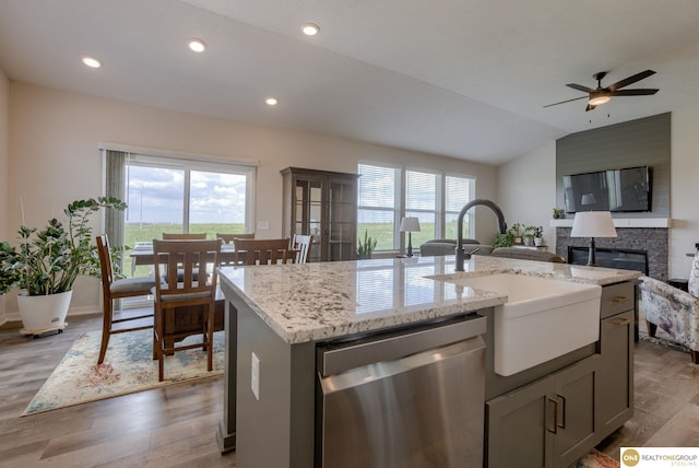 12618 Glenn St, Omaha, NE 68138 - kitchen featuring dishwasher, plenty of natural light, wood finished floors, a stone fireplace, and lofted ceiling