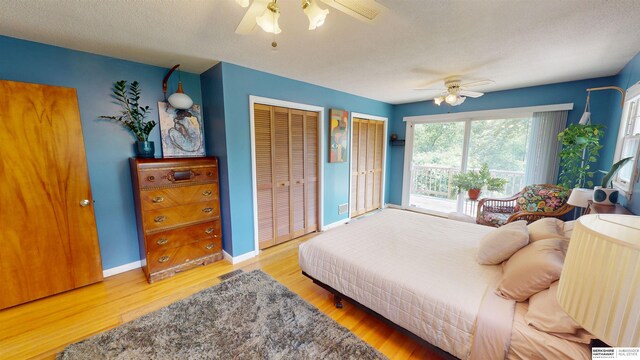7923 Harney St, Omaha, NE 68114 - bedroom with multiple closets, wood finished floors, and a ceiling fan