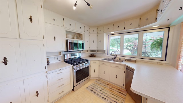 7923 Harney St, Omaha, NE 68114 - kitchen with appliances with stainless steel finishes, light countertops, open shelves, and white cabinetry