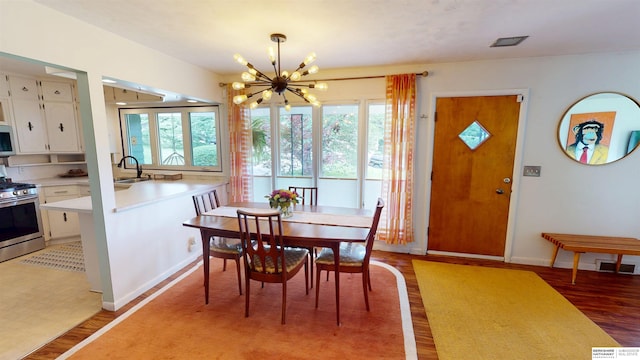 7923 Harney St, Omaha, NE 68114 - dining space featuring a chandelier and light wood-style floors