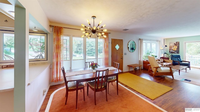 7923 Harney St, Omaha, NE 68114 - dining area featuring light wood finished floors and a chandelier