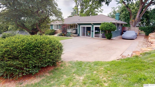 7923 Harney St, Omaha, NE 68114 - rear view of house with a chimney and a patio