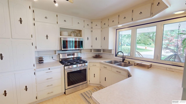 7923 Harney St, Omaha, NE 68114 - kitchen featuring stainless steel appliances, light countertops, white cabinetry, and open shelves