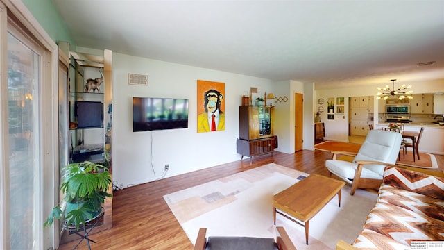 7923 Harney St, Omaha, NE 68114 - living room with a chandelier and light wood-style flooring