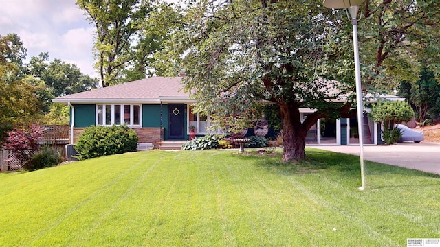 7923 Harney St, Omaha, NE 68114 - view of front of property featuring a front lawn, concrete driveway, and stone siding