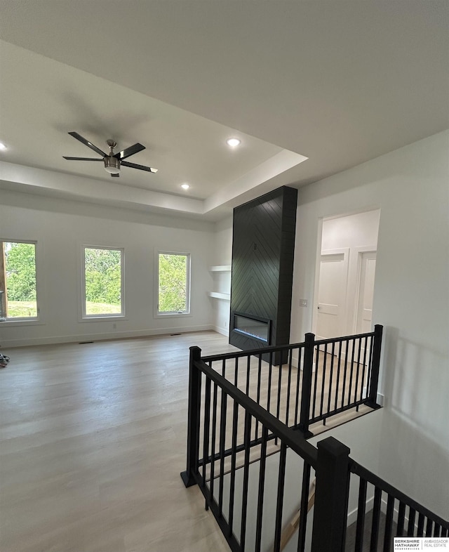 19756 Briar St, Gretna, NE 68028 - hallway with an upstairs landing, a raised ceiling, light wood-style flooring, and recessed lighting