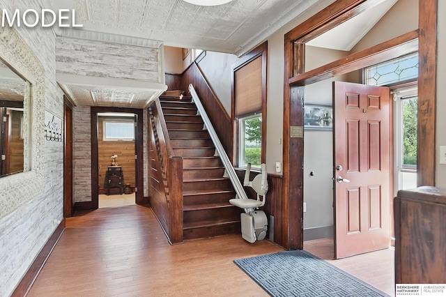 9404 N 294th St, Valley, NE 68064 - entrance foyer featuring stairs, wood finished floors, wooden walls, healthy amount of natural light, and an ornate ceiling