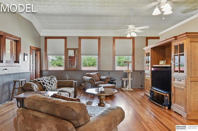9404 N 294th St, Valley, NE 68064 - living area featuring wainscoting, ceiling fan, light wood-style flooring, plenty of natural light, and crown molding