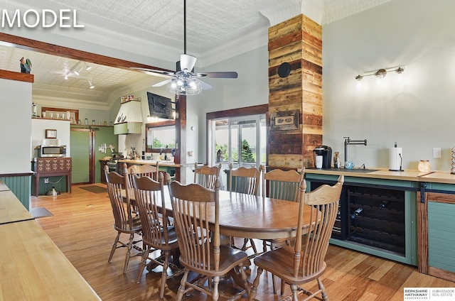 9404 N 294th St, Valley, NE 68064 - dining space with beverage cooler, a ceiling fan, wood finished floors, and a towering ceiling