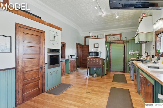 9404 N 294th St, Valley, NE 68064 - kitchen with stainless steel appliances, track lighting, light wood finished floors, light countertops, and crown molding