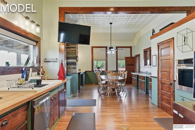 9404 N 294th St, Valley, NE 68064 - kitchen featuring appliances with stainless steel finishes, light wood-style floors, butcher block countertops, a ceiling fan, and an ornate ceiling