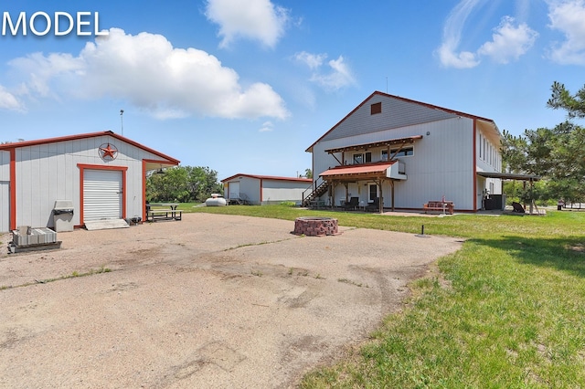 9404 N 294th St, Valley, NE 68064 - back of house with a fire pit, a yard, a deck, an outbuilding, and stairway