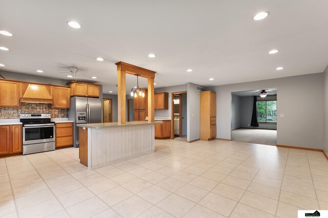 9521 N 140th St, Waverly, NE 68462 - kitchen with appliances with stainless steel finishes, custom exhaust hood, a ceiling fan, light countertops, and decorative backsplash
