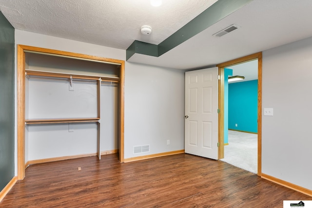 9521 N 140th St, Waverly, NE 68462 - unfurnished bedroom with wood finished floors, a closet, and a textured ceiling