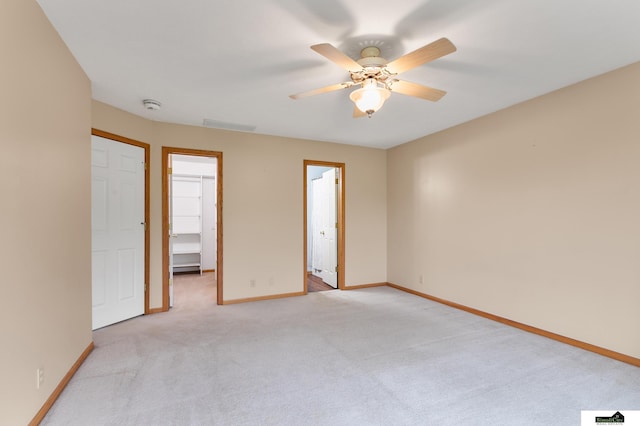 9521 N 140th St, Waverly, NE 68462 - unfurnished bedroom featuring a spacious closet, light colored carpet, a closet, and a ceiling fan