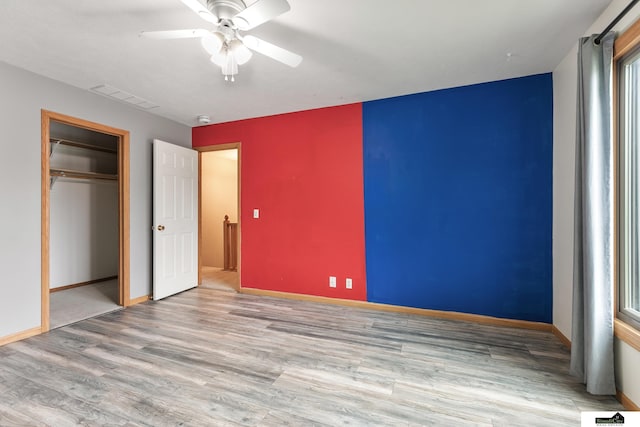 9521 N 140th St, Waverly, NE 68462 - unfurnished bedroom featuring wood finished floors, a ceiling fan, and a closet