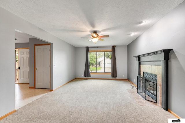 9521 N 140th St, Waverly, NE 68462 - unfurnished living room with carpet floors, a ceiling fan, a fireplace, a textured ceiling, and tile patterned flooring