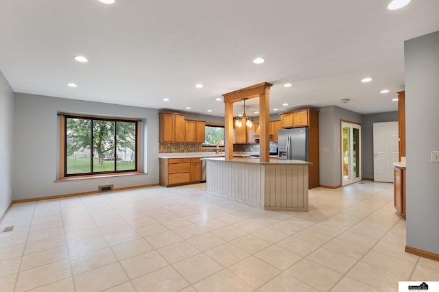 9521 N 140th St, Waverly, NE 68462 - kitchen with appliances with stainless steel finishes, recessed lighting, tasteful backsplash, light countertops, and a kitchen island