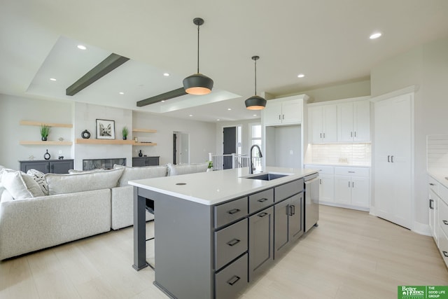 10110 Laramie St, Papillion, NE 68046 - kitchen with stainless steel dishwasher, white cabinetry, gray cabinets, light countertops, and recessed lighting
