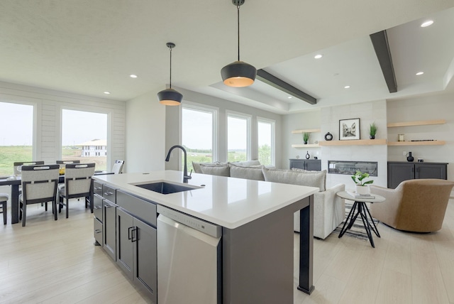 10110 Laramie St, Papillion, NE 68046 - kitchen with stainless steel dishwasher, healthy amount of natural light, light countertops, a center island with sink, and recessed lighting