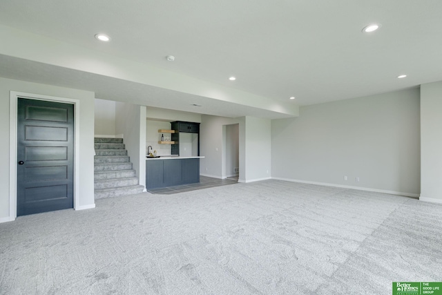 10110 Laramie St, Papillion, NE 68046 - unfurnished living room with light carpet, stairs, and recessed lighting