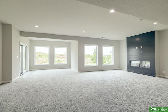 10110 Laramie St, Papillion, NE 68046 - unfurnished living room with carpet, plenty of natural light, recessed lighting, and a multi sided fireplace