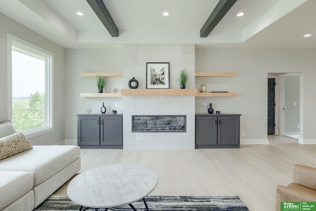 10110 Laramie St, Papillion, NE 68046 - living area with light wood-style floors, a tiled fireplace, and recessed lighting