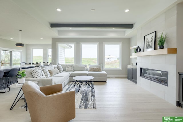 10110 Laramie St, Papillion, NE 68046 - living area with recessed lighting, plenty of natural light, a tile fireplace, light wood-type flooring, and beam ceiling