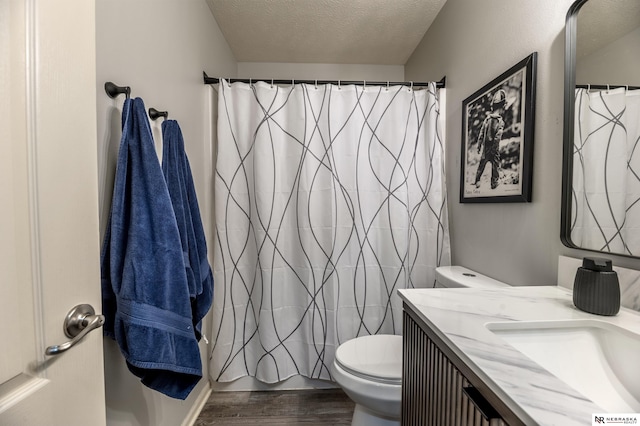 13913 Springview Dr, Papillion, NE 68133 - full bathroom with wood finished floors, vanity, a textured ceiling, and a shower with curtain