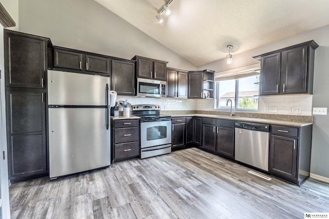 13913 Springview Dr, Papillion, NE 68133 - kitchen featuring stainless steel appliances, vaulted ceiling, light wood-type flooring, open shelves, and decorative backsplash