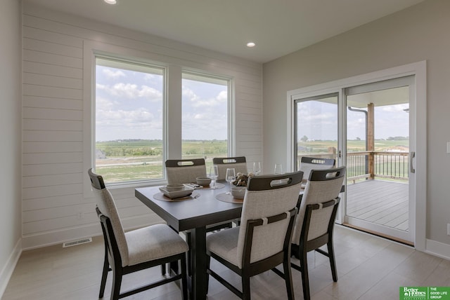 5620 N 212th St, Elkhorn, NE 68022 - dining space with recessed lighting, light wood-type flooring, and wood walls