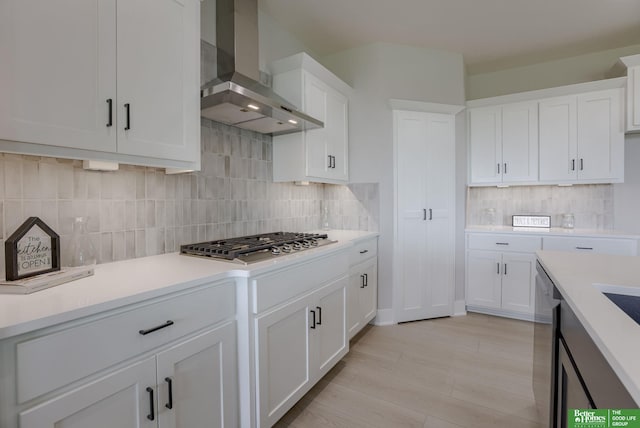 5620 N 212th St, Elkhorn, NE 68022 - kitchen featuring wall chimney exhaust hood, appliances with stainless steel finishes, light countertops, decorative backsplash, and white cabinets