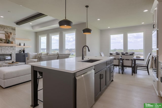 5620 N 212th St, Elkhorn, NE 68022 - kitchen featuring dishwasher, light countertops, light wood-type flooring, an island with sink, and recessed lighting