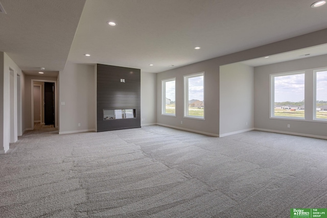 5620 N 212th St, Elkhorn, NE 68022 - unfurnished living room with light carpet, recessed lighting, and a multi sided fireplace