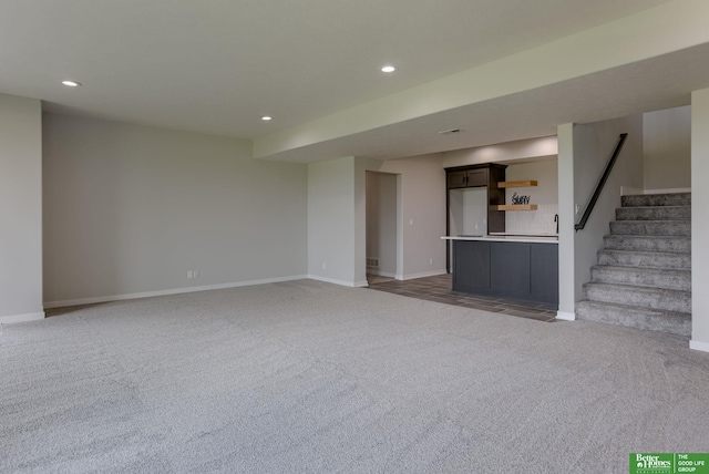 5602 N 212th St, Elkhorn, NE 68022 - unfurnished living room featuring light colored carpet, recessed lighting, and stairs