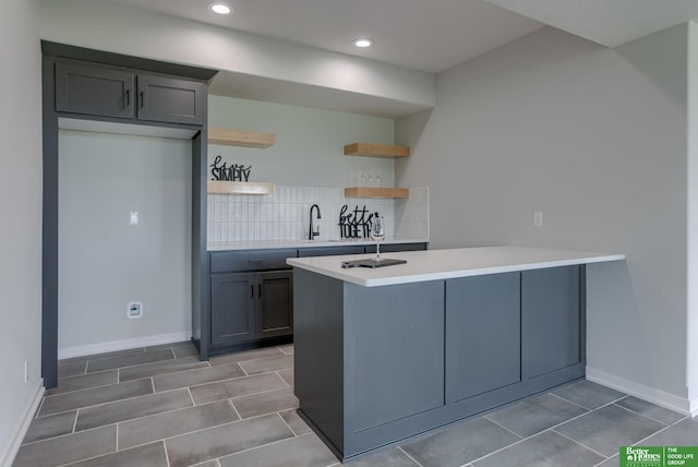 5602 N 212th St, Elkhorn, NE 68022 - kitchen with open shelves, a peninsula, backsplash, light countertops, and tile patterned floors
